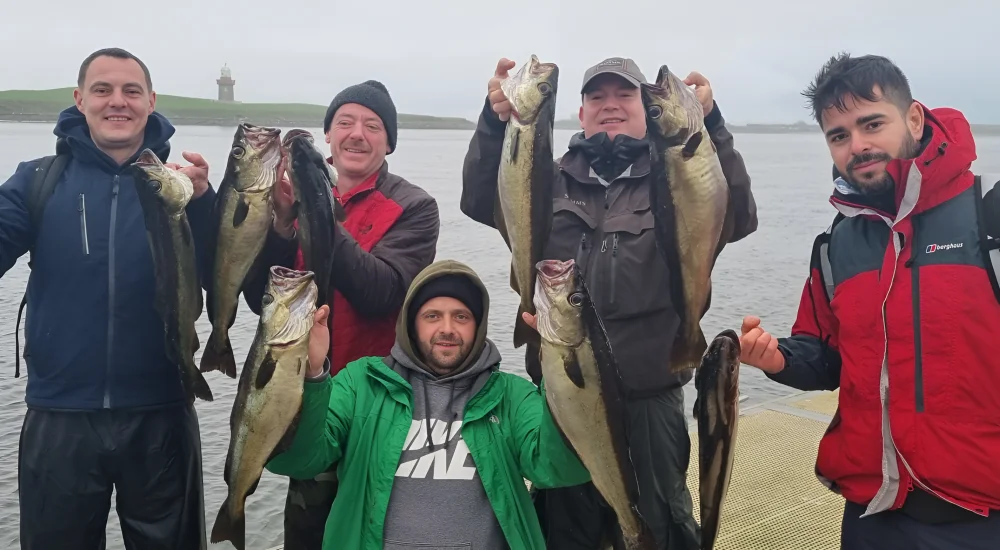 Group of people holding fish | Sligo Activities