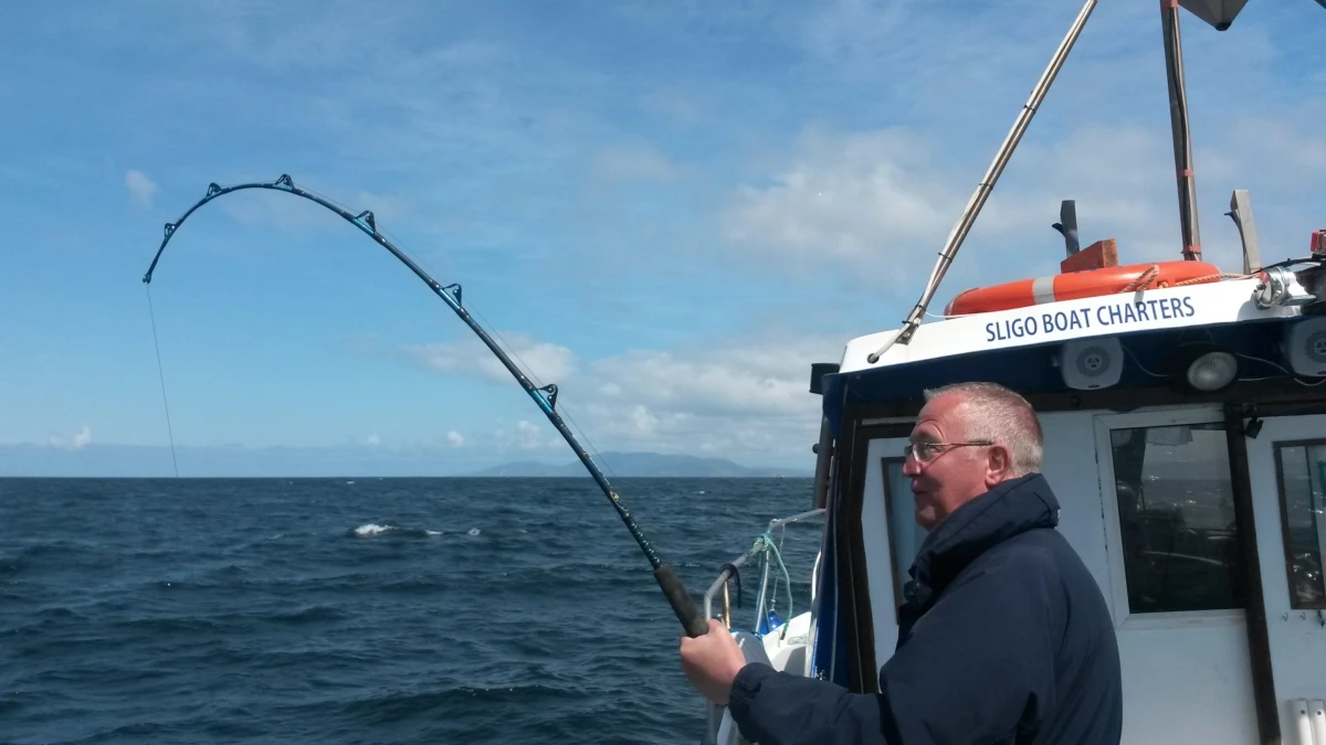 Angler with catch and gear during sea fishing trip