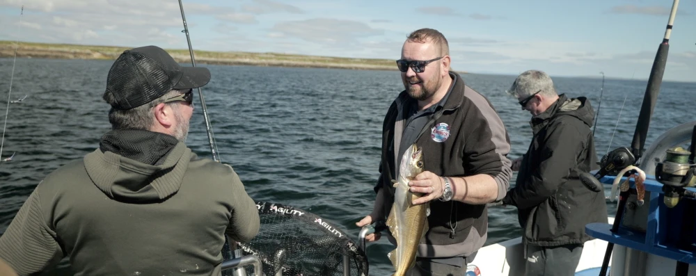 Group of people on Ewings charter holding fish